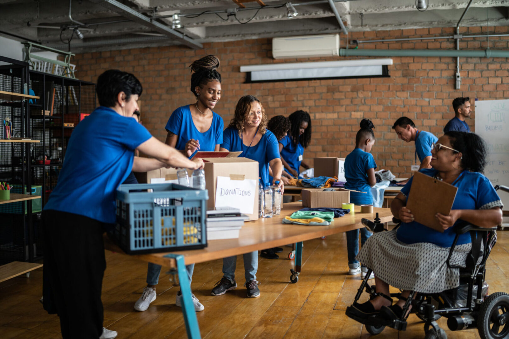 Volunteers organizing supplies in blue shirts